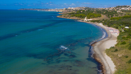 Aerial view of the Sicilian coast overlooking the Mediterranean sea. The sea is rough and the coast is sandy. In the background is the town of Sciacca in Sicily, Italy. Holiday concept. - obrazy, fototapety, plakaty