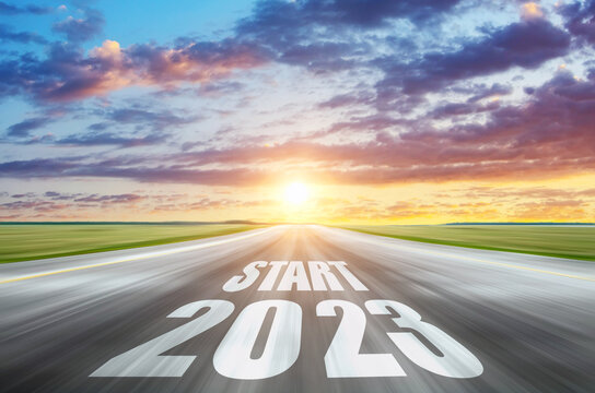 Concept of planning and challenge, business strategy, opportunity, hope, new life change for 2022-2023. Start 2023 written on highway road in the middle of empty asphalt road asphalt road sunrise.