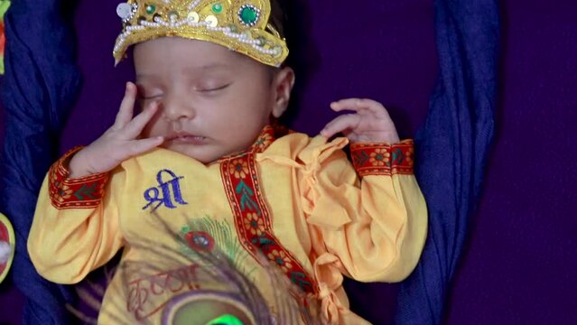newborn baby boy in krishna dressed with props from unique perspective in different expression