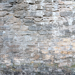 old brick wall made of sandstone blocks of different sizes as a background