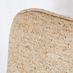 1970s oatmeal tweed vintage loveseat. Detail view of beige fabric texture.