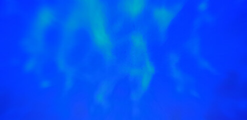 Fototapeta na wymiar Blurry blue water background with light reflections