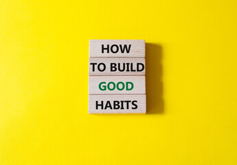 How to build good habits symbol. Concept words How to build good habits on wooden blocks. Beautiful yellow background. Business and How to build good habits concept. Copy space.