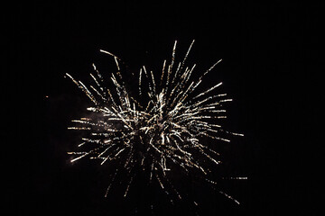 Huge fireworks explosions with Violet and golden colors over a party