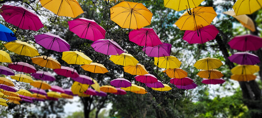 Fototapeta na wymiar street decorated with colorful umbrella in holambra sky