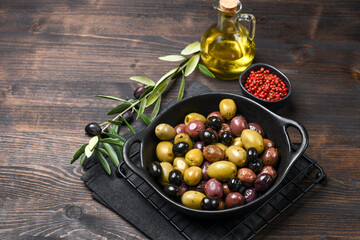 healthy food salad different green and black olives with olive oil and herbs