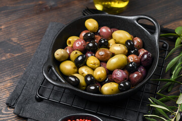 healthy food salad different green and black olives with olive oil and herbs