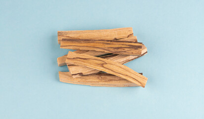 Closeup of Palo santo wood, Bursera graveolens isolated on light blue background