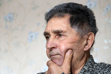 Portrait of elderly man thinking about something. Concept of brain activity in old age and wisdom