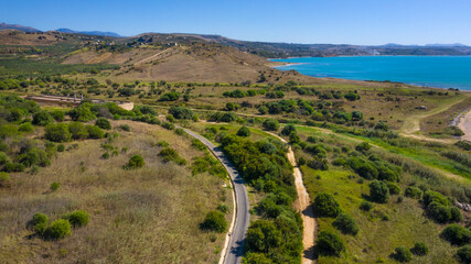 Panoramic view of a stretch of the Sicilian coast overlooking the Mediterranean Sea. Cultivated fields and hills that reach the sea. These beaches are located in Sicily, Italy.  Holiday concept. - obrazy, fototapety, plakaty