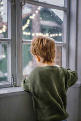 child looking out window