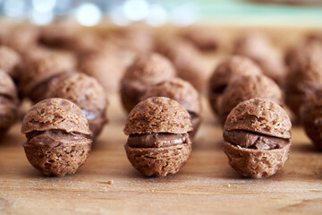 Christmas cocoa cookies filled with cream on a wooden table