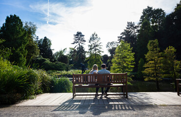 lovers on wooden bench in garden