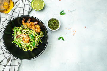Zucchini raw pasta with pesto sauce and grilled shrimp cheese Parmesan, Restaurant menu, dieting, cookbook recipe top view
