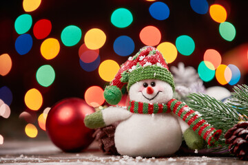cheerful snowman in a knitted hat on a Christmas background.