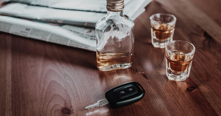 Do not drink and drive concept, Close up of car keys and glass of strong an alcohol rum, driving concept, beware of alcohol