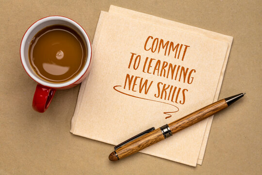 commit to learning new skills - motivational advice or reminder on a napkin with coffee, continuing education and personal development concept