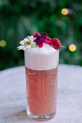 Exotic cocktail with flowers and bokeh