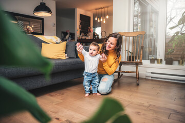 mother and baby girl having great time on the living room