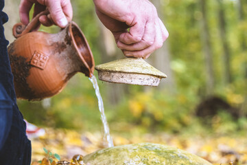 Water pouring from an earthenware jug