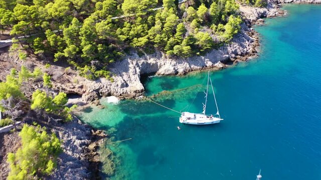 Aerial drone video of beautiful bay and beach of Foki with iconic caves visited by yachts and sail boats, Kefalonia island, Ionian, Greece
