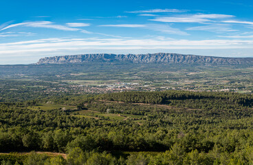 Horizontal panoramic of the iconic Mont Sainte Victoire with a village and woods, Provence, South of France, Europe