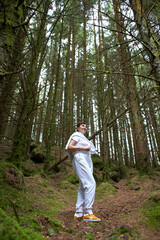 A woman in a sports clothes in irish pine forest