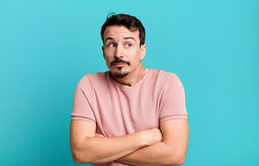 shrugging, feeling confused and uncertain, doubting with arms crossed and puzzled look