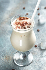 milky coffee cocktail on concrete stone background. vertical image. place for text