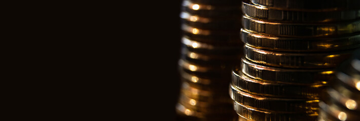 Gold coins on black background.