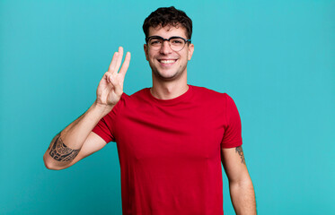 smiling and looking friendly, showing number three or third with hand forward, counting down