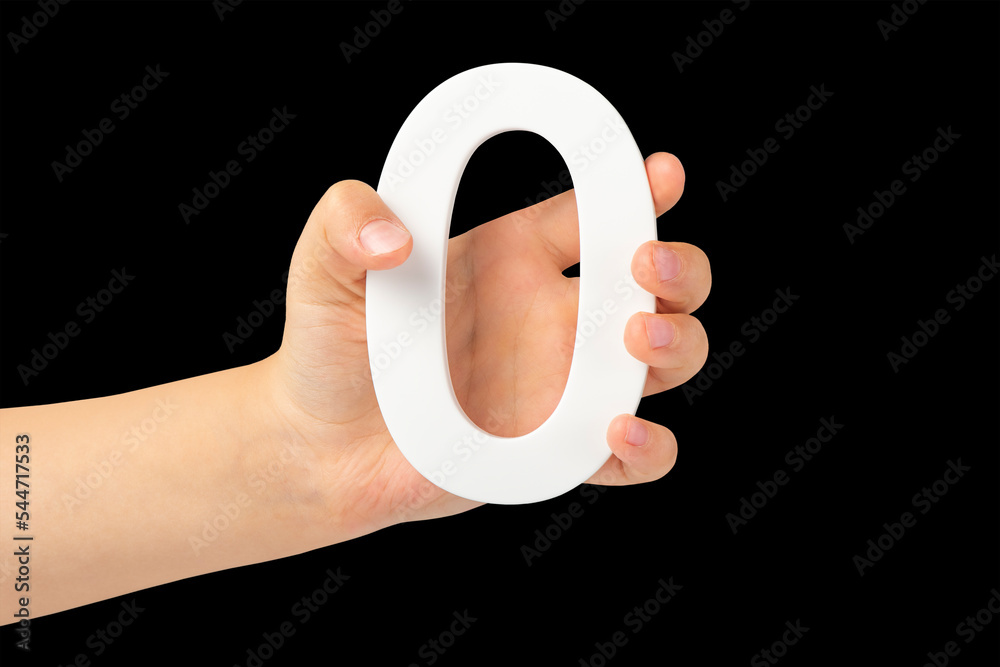 Aufkleber zero in hand. the number zero is clasped in a hand isolated on a black background. number zero white
