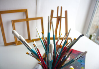 Still life with brushes, palette and easel	

