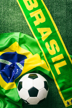 Sports: Brazil Scarf and Flag on Soccer Background