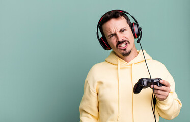adult man feeling puzzled and confused with headset and a control. gamer concept © kues1