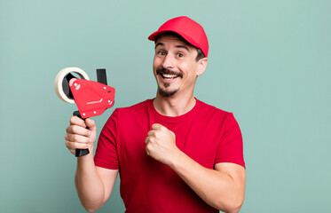 adult man feeling happy and facing a challenge or celebrating. deliveryman packer concept