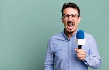 adult man shouting aggressively, looking very angry with a microphone. presenter or journalist...