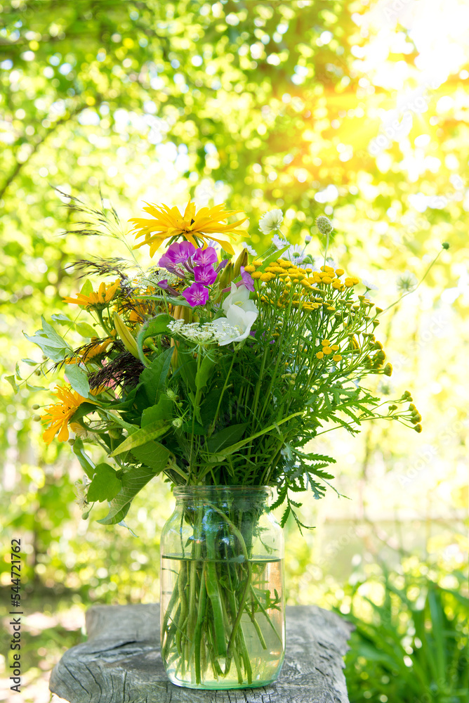 Canvas Prints Bouquet of bright different yellow meadowsweet flowers in a simple glass jar on a natural background	