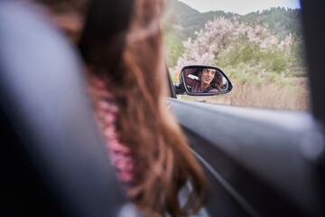 pretty girl reflected in the car mirror