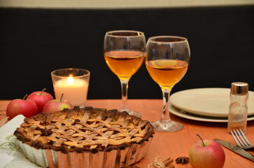 Thanksgiving dinner. Seasonal table setting with autumn leaves, candles and pumpkins.