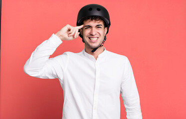 adult man feeling confused and puzzled, showing you are insane. city motorbike rider concept