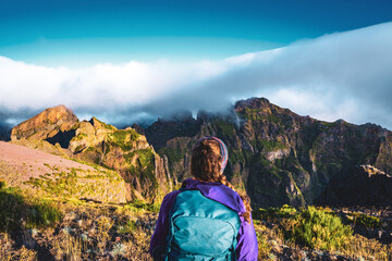 Hiker looking at the beautiful mountain scenery of Pico Ruivo in the morning. Pico do Arieiro,...