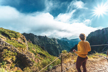 Hiker enjoying mountain scenery from scenic hike trail to Pico Ruivo in the morning. Pico do Arieiro, Madeira Island, Portugal, Europe.