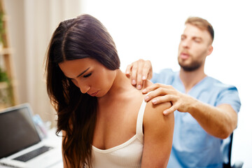 Young woman with neck pain is being examined by a physiatrist