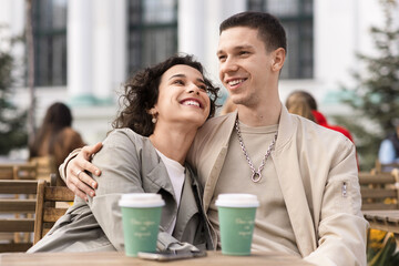 A happy couple outdoors near a cafe