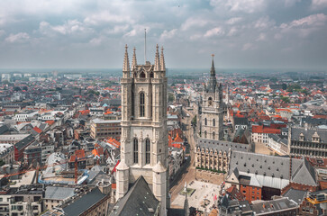 Fototapeta na wymiar Aerial summer cityscape of the Old Town in Ghent (Gent), Belgium. Sint-Baafskathedraal cathedral and Het Belfort van Gent tower in the foreground