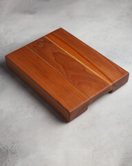 Wooden cutting board in the kitchen on a light background