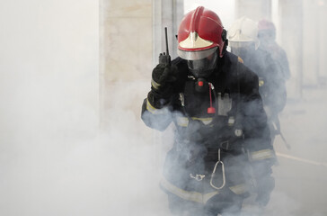 Rescuers firefighters go into the smoke in the subway.