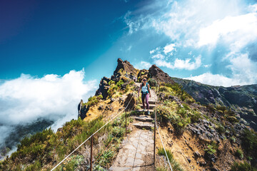 Sportive hiker with backpack walking along super scenic hike trail to Pico do Ariero in the...