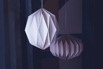 Abstract geometric decorative paper shapes in the form of lamps.